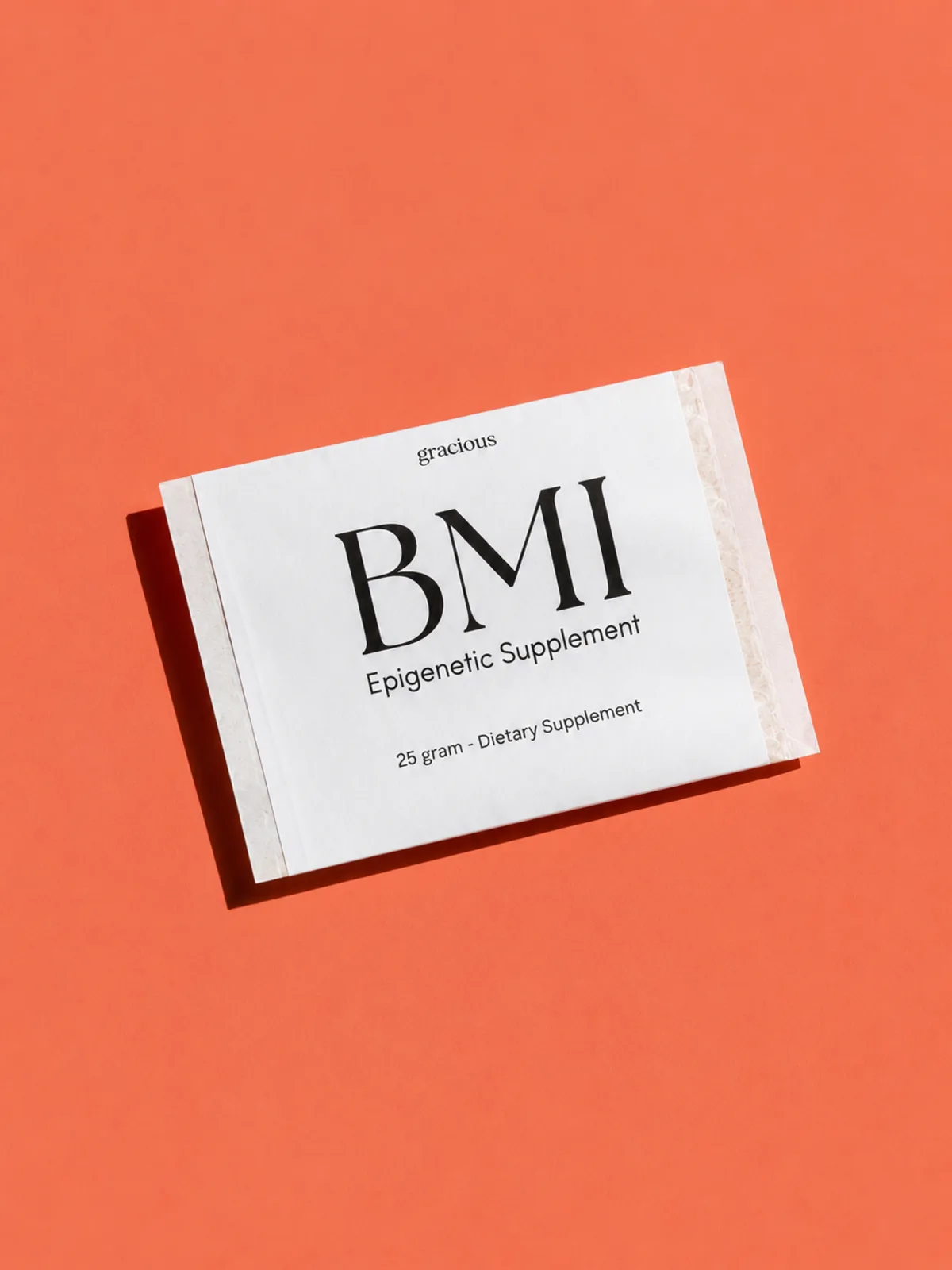 Gracious BMI epigenetic supplement sachet on a coral background