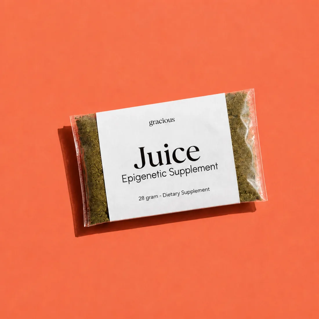 Gracious Juice sachet of whole-plant powder on a coral background